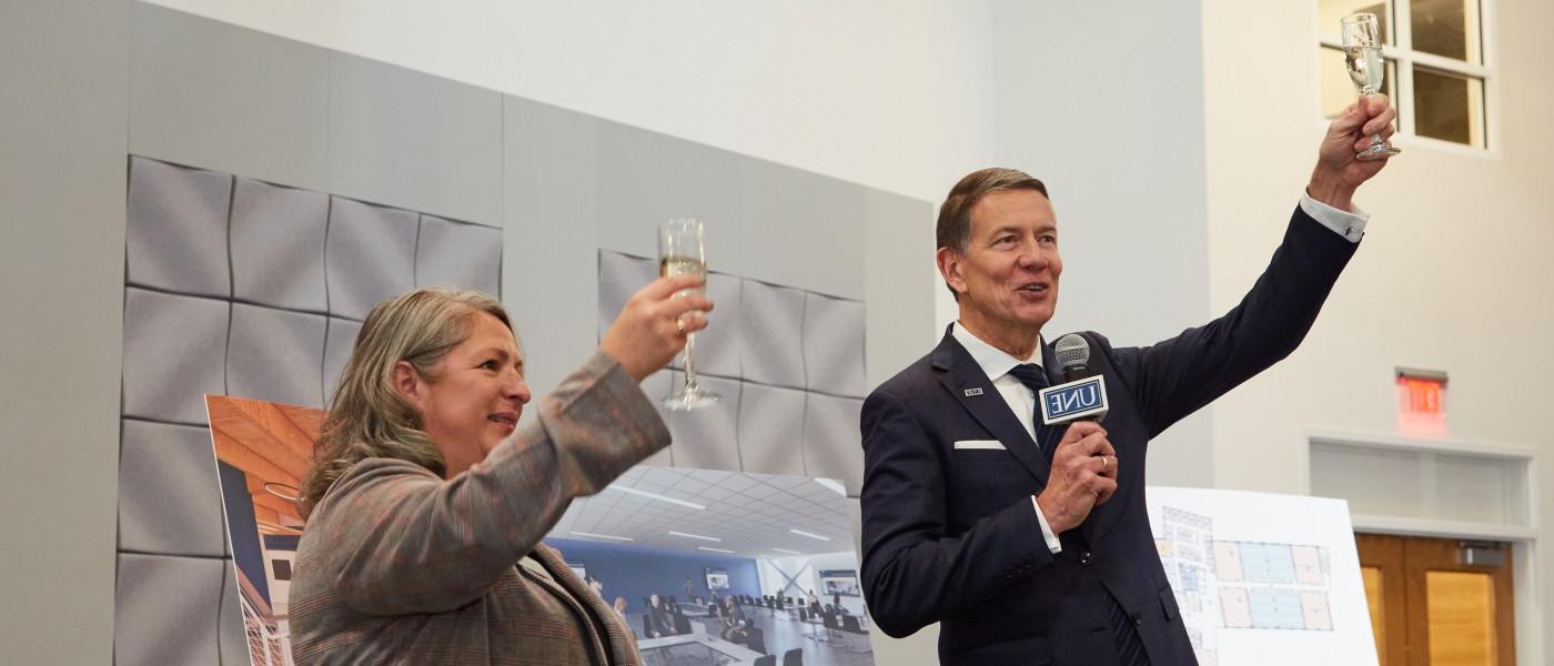 President Herbert raises a toast to the new college of osteopathic medicine on U N E's portland campus