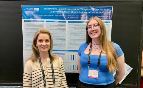 Emily Newborough poses with Jennifer Stiegler-Balfour in front of their research poster